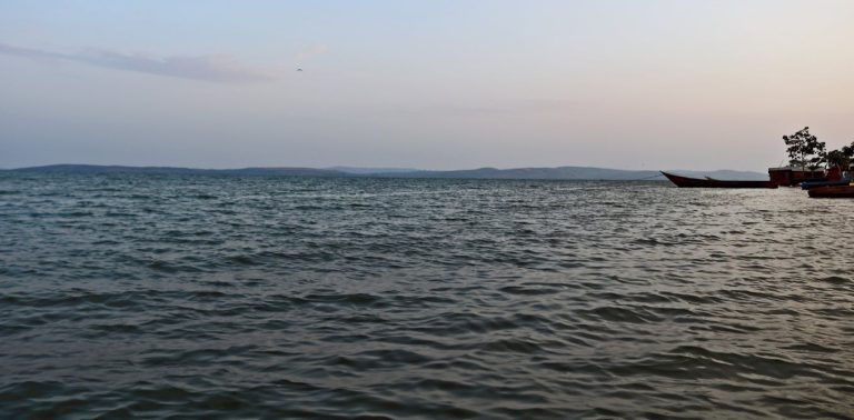 Sunscreen for lakes and dams: could a thin floating layer of nanomaterial shield water from evaporation?